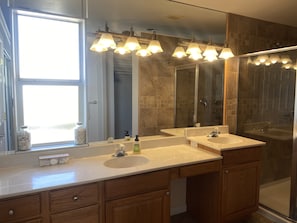 Bathtub, rainfall showerhead, hair dryer, towels