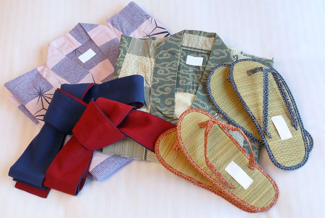 A collection of traditional Japanese footwear and fabric items.