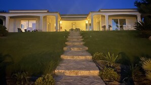 A two-story house with a stone staircase leading to the entrance. - VILLA PORTICCIO SWIMMING POOL EXCEPTIONAL SEA VIEW - BEACH 5 mn -GARDEN LANDSCAPE (Corse)