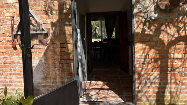 A brick building with a large open doorway leading to a dark interior. - VILLA LA PINETA DI SINALUNGA - Valdichiana and Val d'Orcia for family or friends (SINALUNGA)