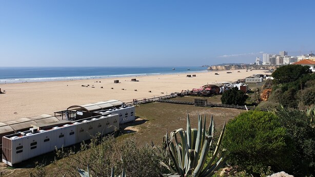 A beach view with a white RV and a large agave plant in the foreground. - Tarik  by Atlantichotels (Portimão)