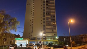 A tall building with multiple floors, a visible sign for 'TARIK', and several parked cars in front. - Tarik  by Atlantichotels (Portimão)