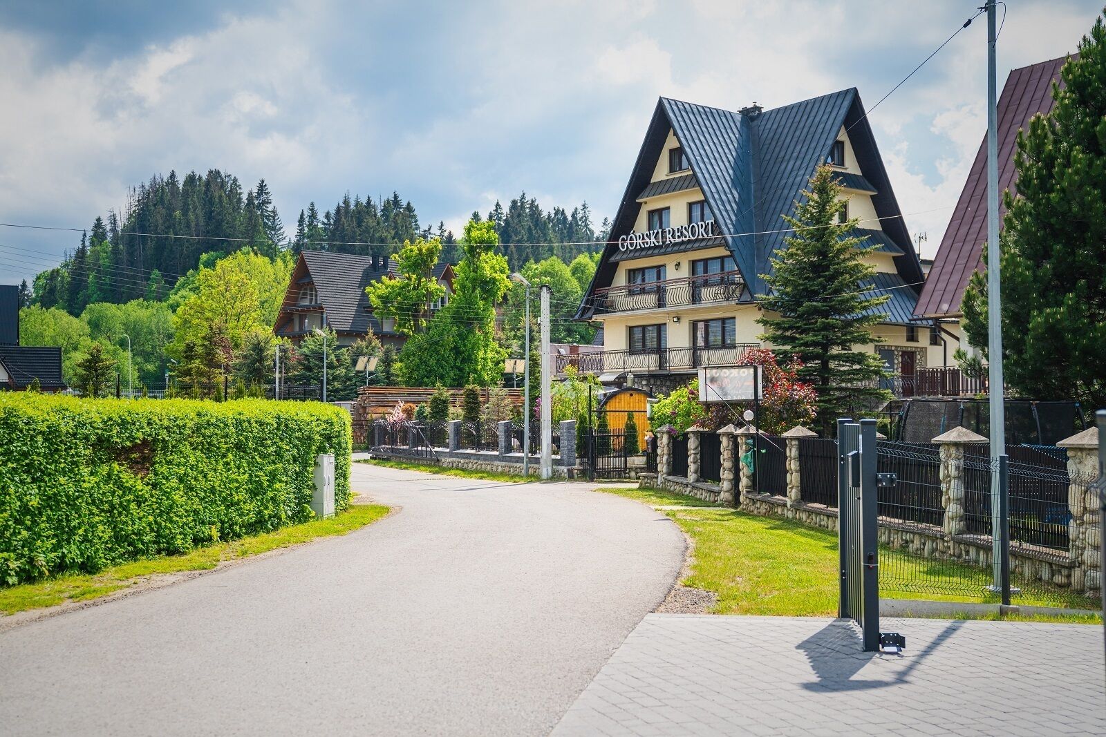 A Gorski Resort with a prominent building featuring a steep roof and a balcony.