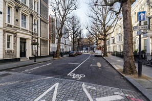 A street lined with traditional brick buildings, a designated bike lane, and a 'One way' sign. - Elegant Earl's Court 2 bed 2 Bath Near Tube (London)