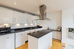 Microwave, oven, dishwasher, dining tables