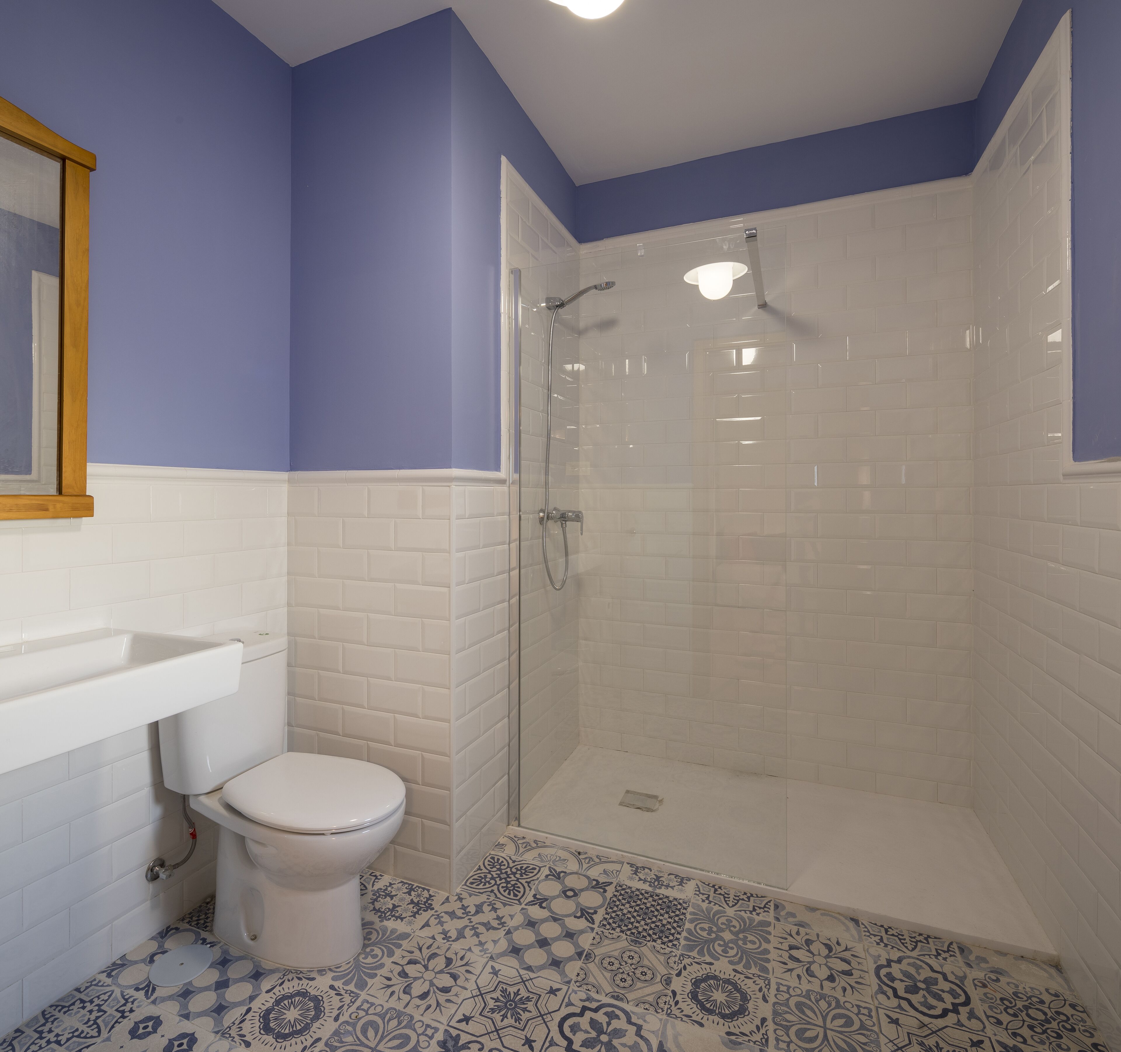 A bathroom with a toilet, a sink, and a shower.