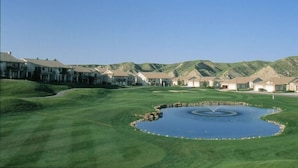 A golf course with a pond, surrounded by residential buildings. - Paradise Canyon Golf Resort (Lethbridge)
