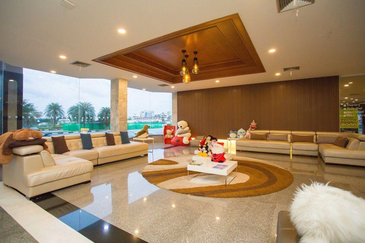 A modern living room with a large window, a sofa set, a coffee table, and a decorative rug.