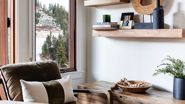 A cozy room with a wooden chair, a small table, and a window with a view of a snowy landscape. - The Village at Palisades Tahoe Bldg 1 - Chic Condo with Prime View (Olympic Valley)