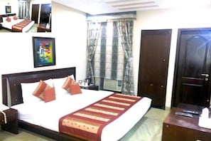 Relax in comfort with a large bed, framed artwork, and a convenient table nearby.