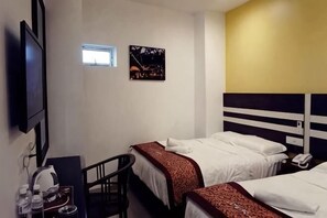 A hotel room with two beds, a desk with a chair, a TV, and a small window. - HOTEL KRISTAL SERI ISKANDAR (Bota)