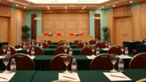 A conference room with rows of tables, chairs, and water bottles. - Argyle International Airport (Shanghai)