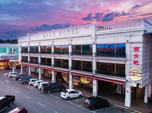 A multi-story hotel with a prominent sign reading 'J.C. Mark Hotel.'