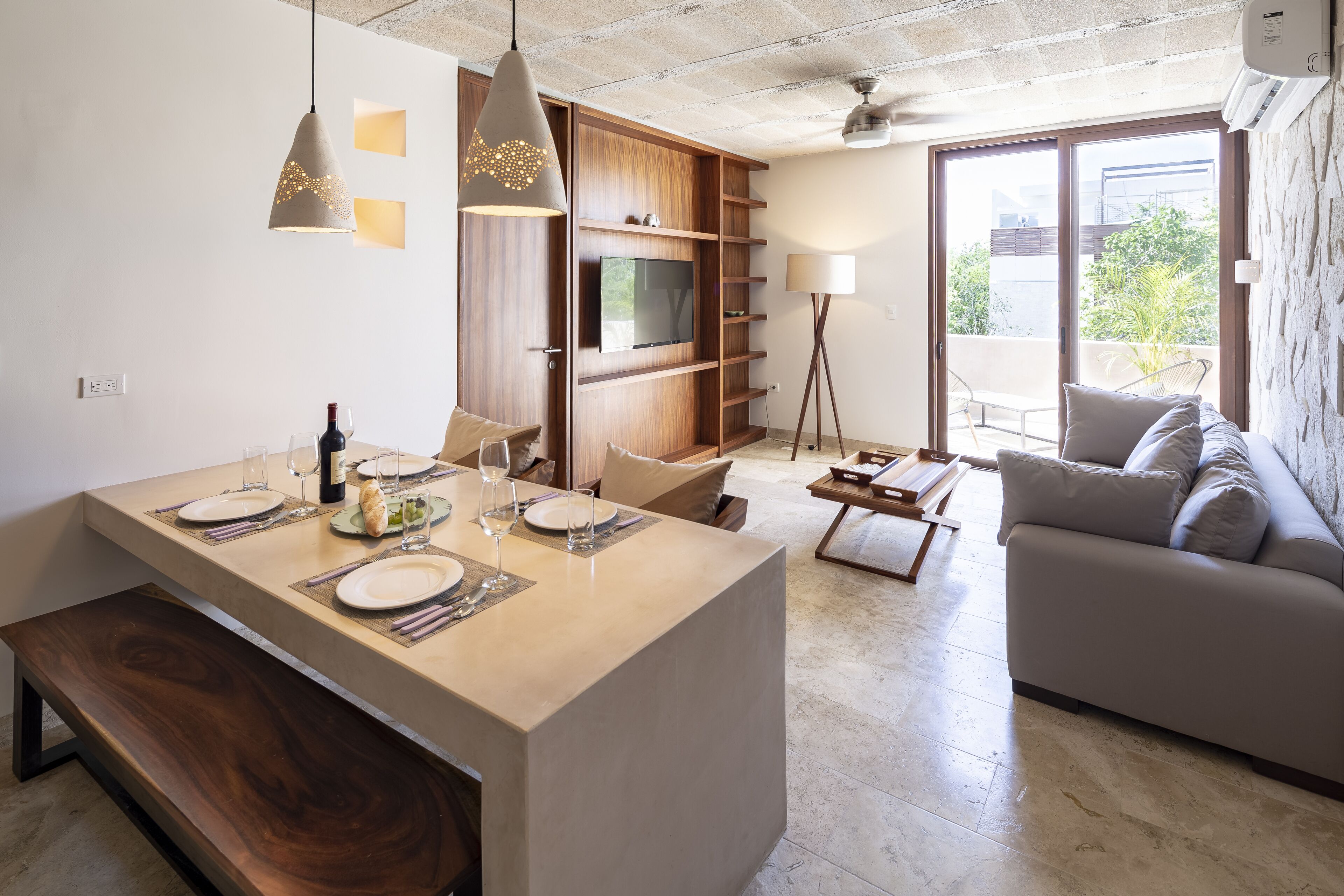 A modern living space with a kitchen island, dining area, and seating area.