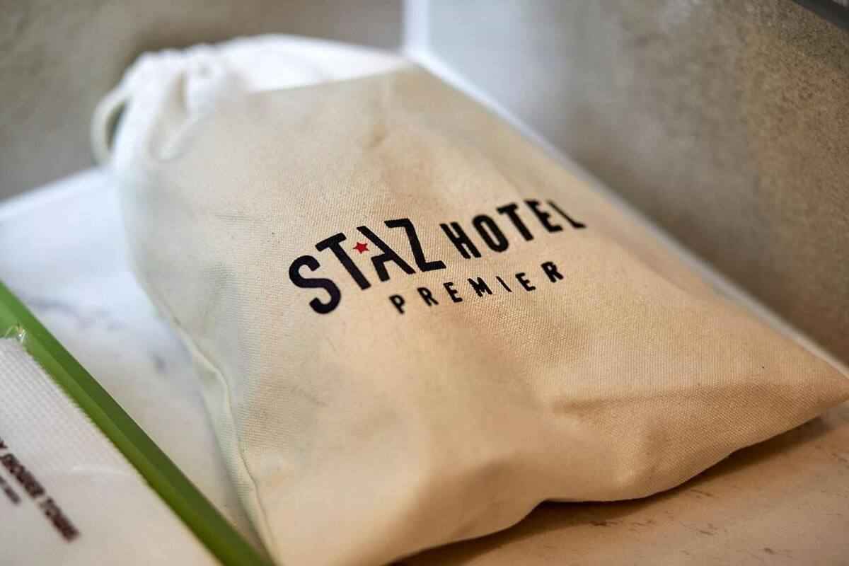 A drawstring bag with the text "STAZ HOTEL PREMIER" on it.