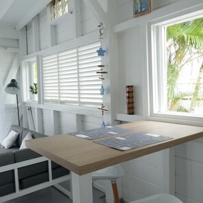 Relax in this airy room with a comfortable sofa and desk near a large window.