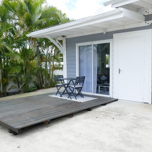 Relax on the elevated deck surrounded by lush tropical plants and enjoy the serene views.