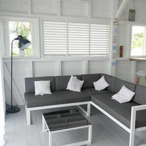 Relax in this stylish living room with a comfortable sofa, coffee table, and floor lamp.
