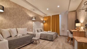 A modern hotel room with a sofa, two beds, a desk, and a TV. - Veneto Suite Rome (Rome)