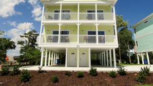 A two-story building with a balcony on each floor, a covered front porch, and a door with a small window. - Stay & Play: Pet Friendly Extended Stay for Sports Travel
Covered Parking (Myrtle Beach)