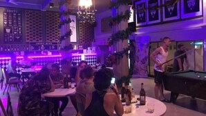 A bar area with pool tables, seating, and a DJ booth. - You empire Hostel and Bar (Pakse)
