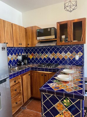 Fridge, microwave, stovetop, coffee/tea maker