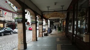 A cobblestone street with a café named Café Prunelle.