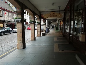A cobblestone street with a café named Café Prunelle.
