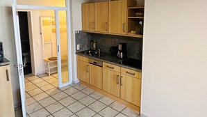 A compact kitchen with wooden cabinets, a countertop, and a sink.