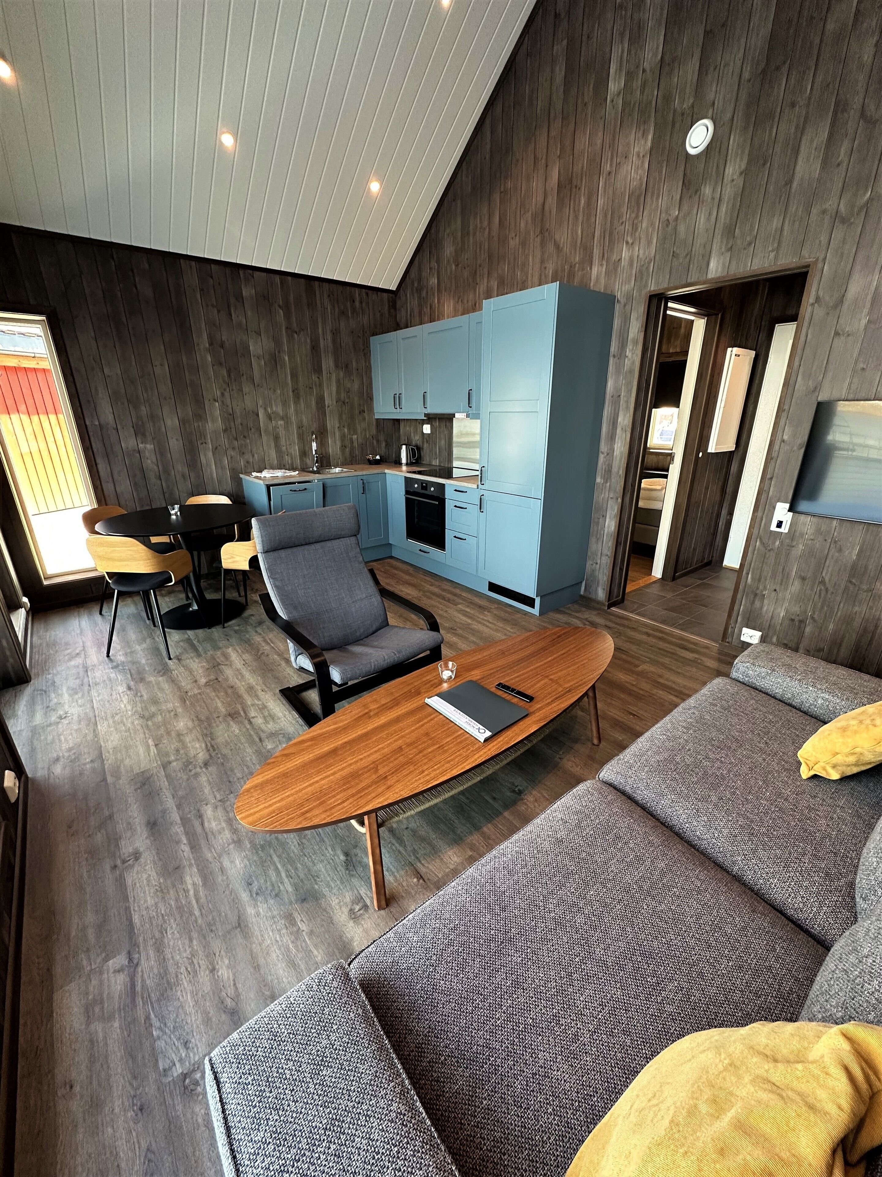 Ein modernes Interieur mit Essbereich, einer Couch und einer Küche.