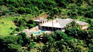 An aerial view of a house with a swimming pool, surrounded by dense greenery. - The Carib House 5 Bedrooms And Pool Close To Beach (Falmouth Harbour)