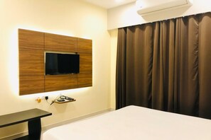Deluxe Room | Desk, laptop workspace, blackout curtains, iron/ironing board - Hotel Golden I (Raipur)
