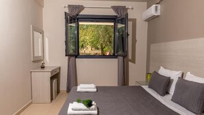 Un dormitorio con cama, mesita de noche, espejo y ventana abierta con cortinas.
