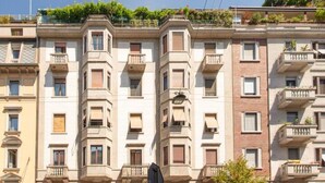 A multi-story residential building with balconies, a central courtyard, and a mix of brick and plaster facades. - Dream House (Milano)