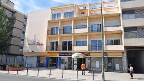 A multi-story building with a sign for 'Residencia Paris' and 'Montepio' on the ground floor. - Hostel Paris (Marinha Grande)