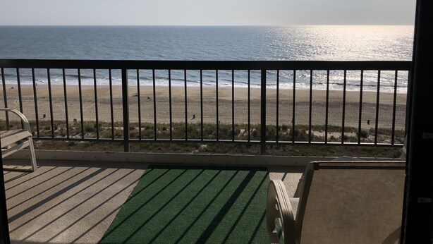 A balcony with a view of the beach and ocean. - Direct Oceanfront Condo remodeled with Breathtaking Views from two private decks (Ocean City)