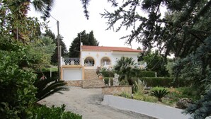 A house with a stone staircase leading to a gated entrance, surrounded by lush greenery and a small pool. - Villa Southern Comfort by CorfuEscapes (Corfu)