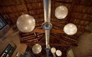 A ceiling with four spherical chandeliers and a central ventilation duct.