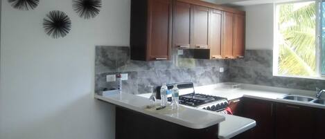 Coffee/tea maker, cookware/dishes/utensils, dining tables