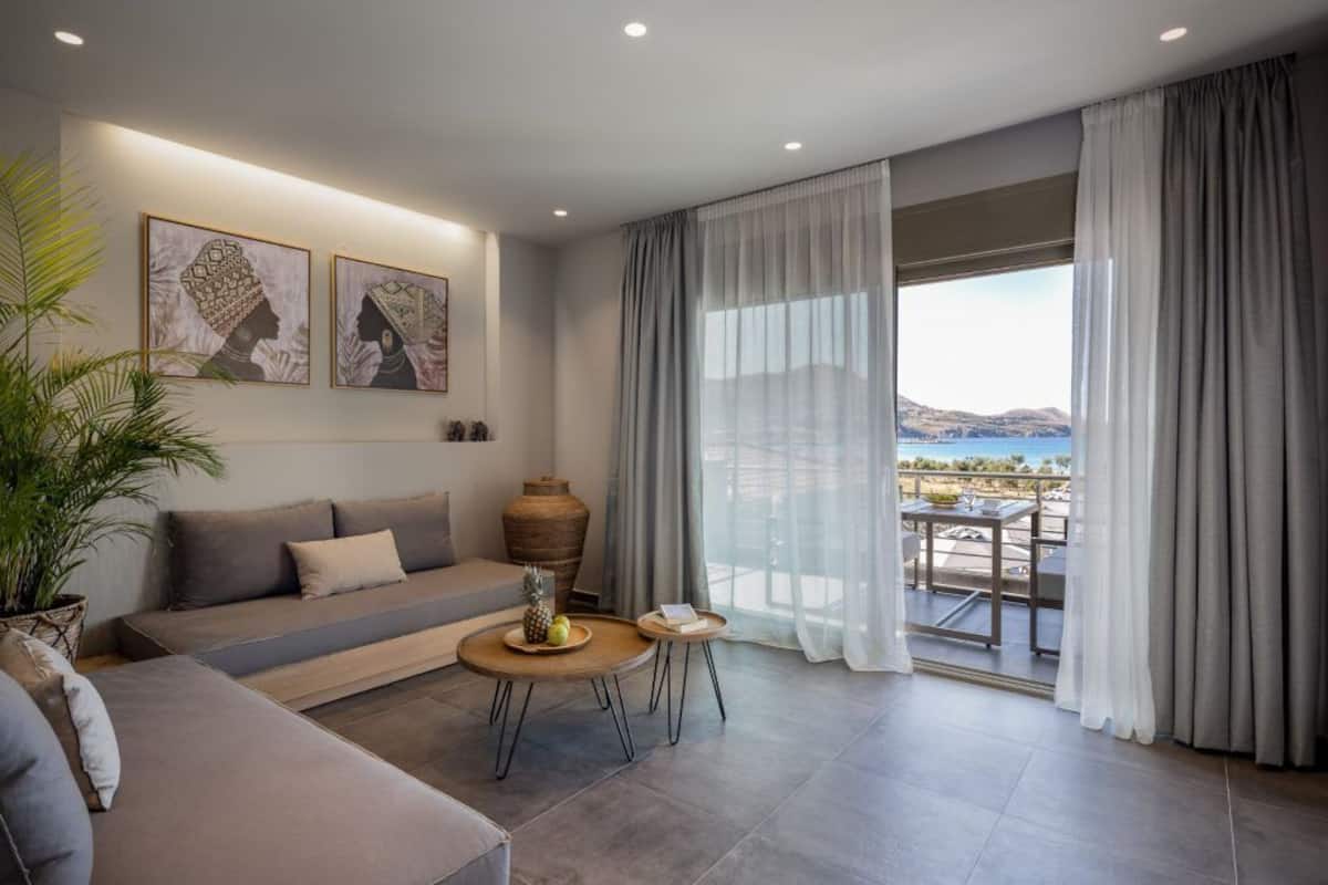 A modern living room with a sofa, a coffee table, and artwork on the wall.