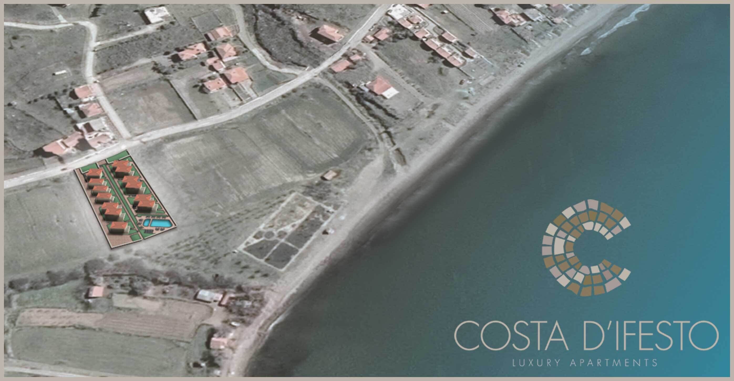 An aerial view of a coastal area with a section of land marked for luxury apartments.