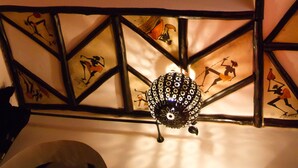 A decorative wall with geometric patterns and silhouettes of dancers. - Riad Bab Essaouira (Essaouira)