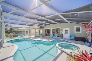 A covered outdoor swimming pool with lounge chairs and a patio area. - Private Pool & Spa On Golf Resort! 5 Bedroom Villa by RedAwning (Davenport)