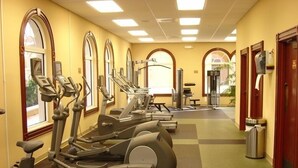 A gym with treadmills, elliptical machines, and weight machines. - Regal Palms Resort 4 Bedroom Townhome! Townhouse by RedAwning (Davenport)