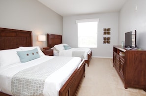A hotel room with two beds, a dresser, a television, and a window with blinds. - Vista Cay Gem 3 Bedroom Condo by RedAwning (Orlando)