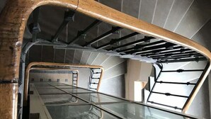 A staircase with a glass enclosure at the bottom.