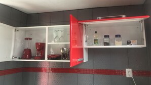 A kitchen with a red refrigerator, a blender, and a sink. - La Casita Salesiana Aguascalientes (Aguascalientes)