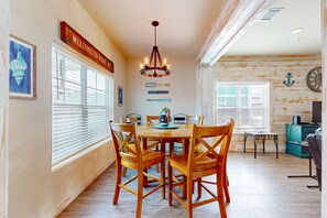Enjoy meals in this cozy dining area with a wooden table and four chairs.