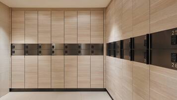 A modern elevator area with numbered panels from 01 to 26.