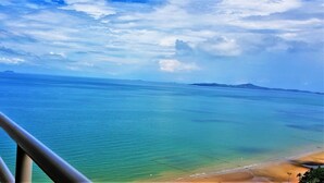 A balcony with a view of a beach and ocean. - Beach Condo with Stunning Sea Views - Sleeps 2 (Pattaya)